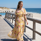 👗 Letnia sukienka maxi w kwiaty z odkrytymi ramionami i falbanami – elegancka, zwiewna i idealna na słoneczne dni 🌸☀️